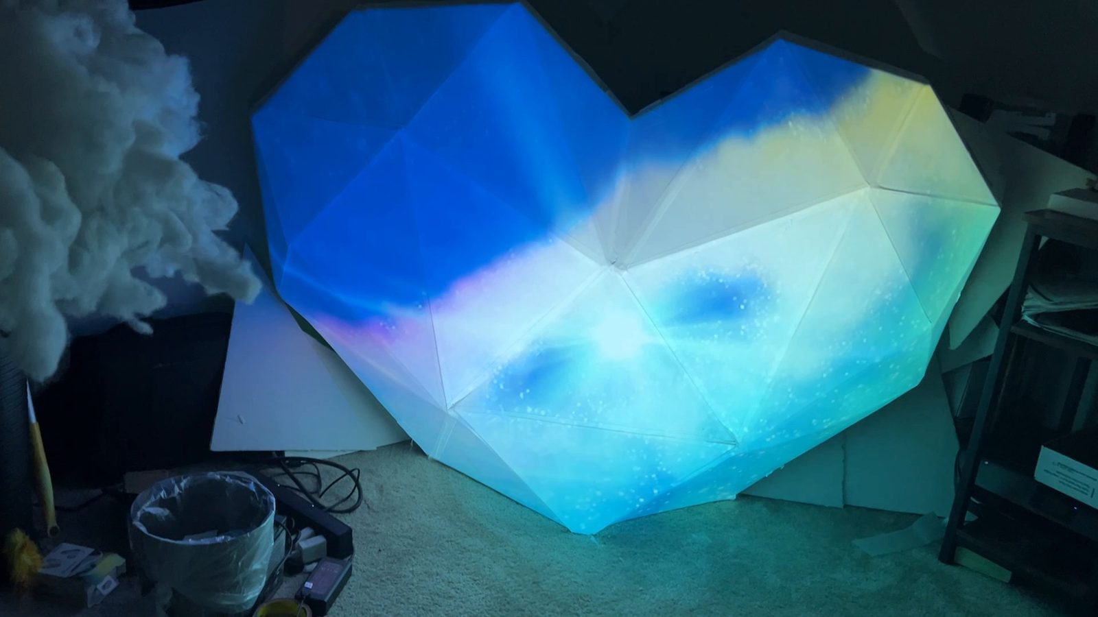 FIOH v1 in corrugated plastic, projection-mapped with blue clouds in the studio